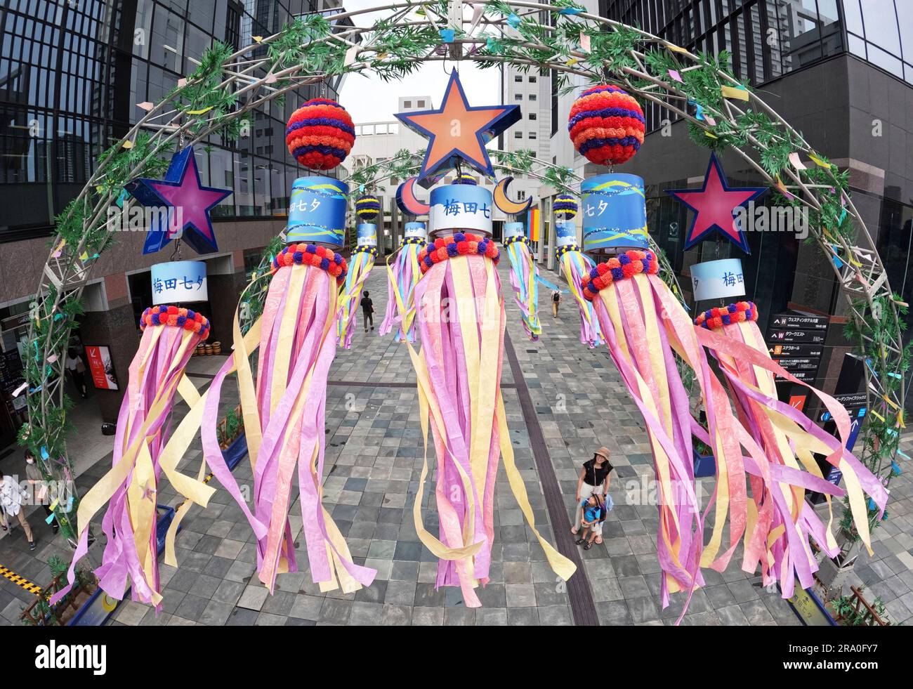 Windsocks are hung Qixi Festival (Qiqiao Festival) at the Umeda Sky Building in Osaka City, Osaka Prefecture on June 30, 2023. The Qixi Festival is a Chinese festival celebrating the annual meeting of Zhinü and Niulang in Chinese mythology. These streamers are borrowed from Sendai Tanabata festival.( The Yomiuri Shimbun via AP Images ) Banque D'Images