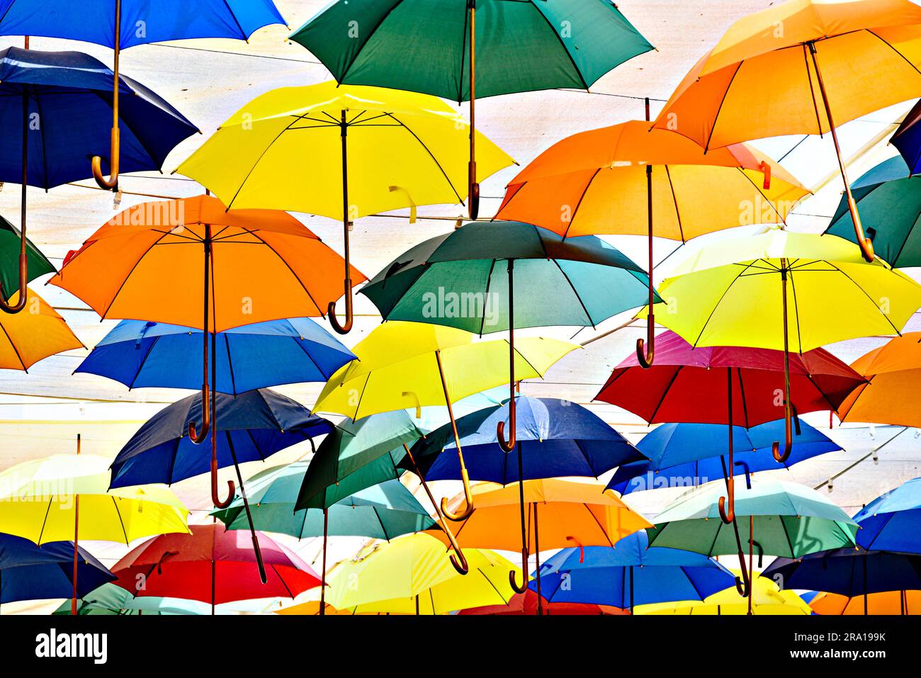 Arrière-plan de nombreux parasols colorés suspendus décorant la rue d'une ville Banque D'Images