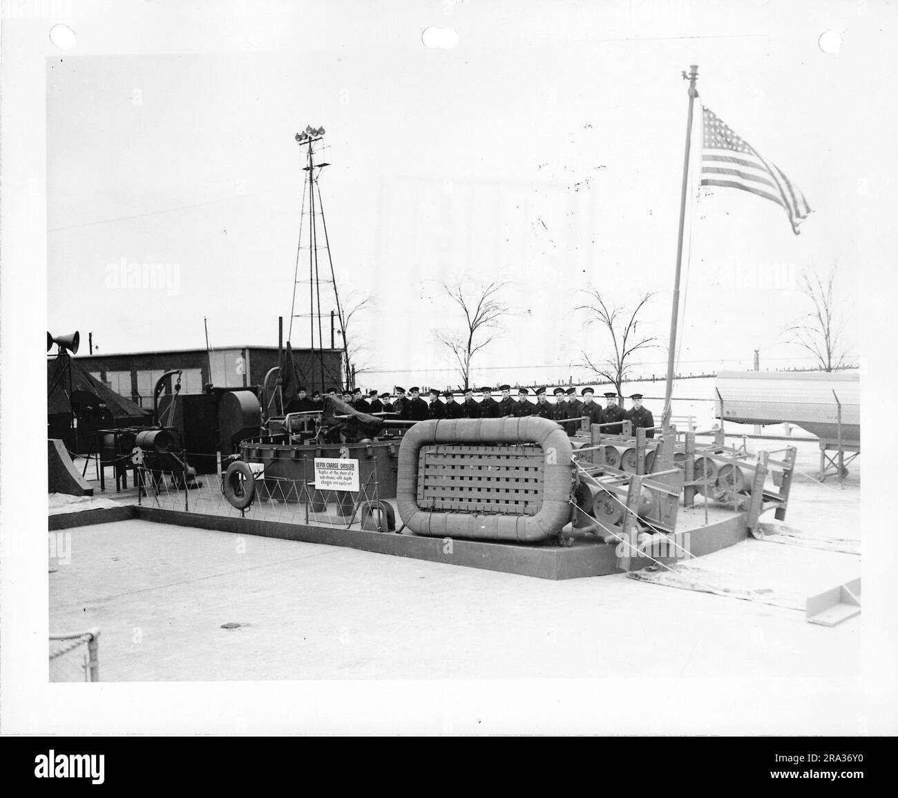 Photographie d'individus militaires debout derrière la réplique percutante de charge de profondeur - Un navire utilisé pour Chase sous-marins. Banque D'Images