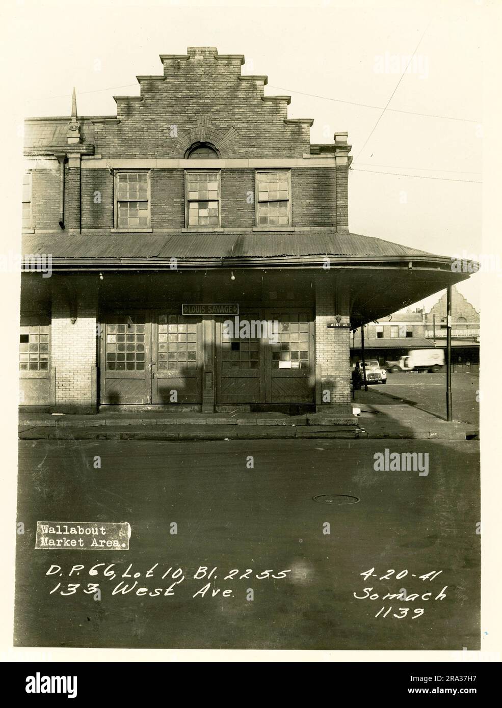 Photographie du marché extérieur du mur, D.P. 66, lot 10, Bl. 2255, 133 West Ave. Vue sur la façade de la boutique Louis Savage avec détails architecturaux, panneau de rue West Ave sur le bâtiment, et voiture, camion en arrière-plan, du négatif 1139. Banque D'Images