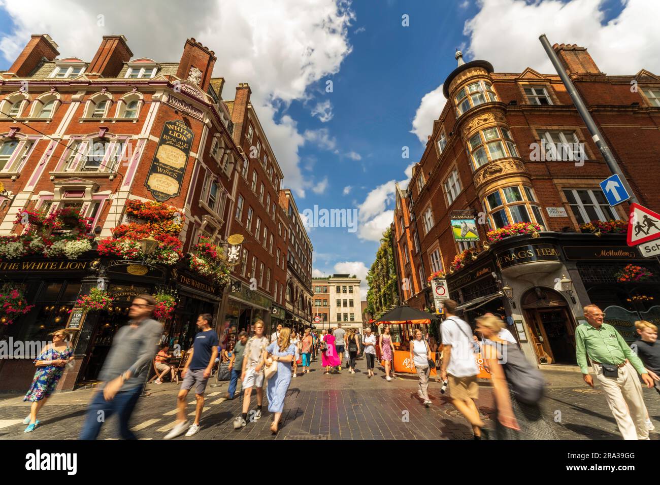 Rue bondée de la ville remplie de touristes au marché de Covent Garden dans la ville de Londres avec des boutiques populaires, des restaurants et des pubs. Une attraction britannique de premier plan. Banque D'Images