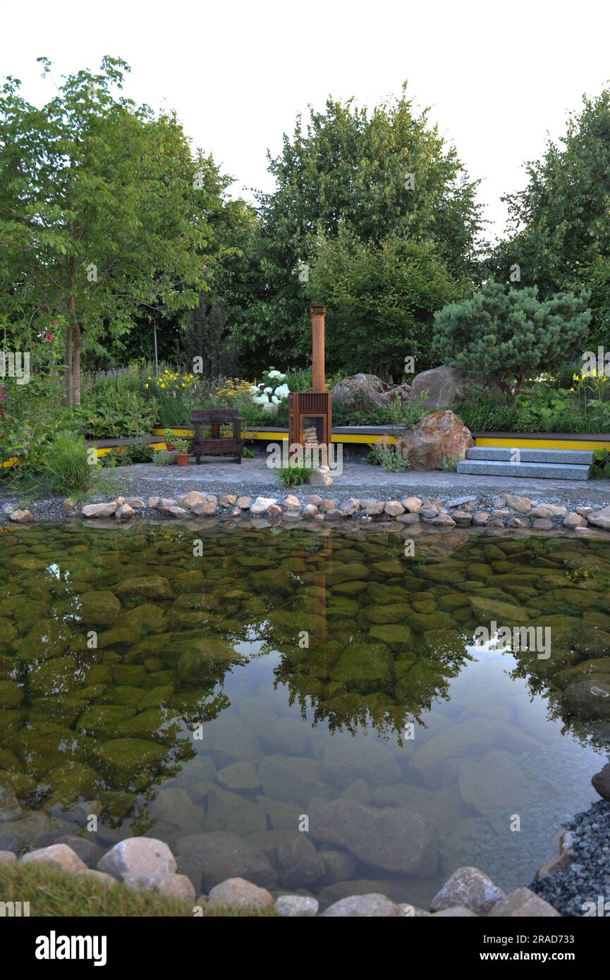 Journée d'ouverture à la Royal Horticultural Society 2023 Hampton court Palace Garden Festival - l'un des jardins de spectacle exposés: Hurtigruten: Le jardin relation-bateau le jardin met en évidence la relation entre Hurtigruten et ses agriculteurs côtiers norvégiens. L'espace se concentre spécifiquement sur un fruitier basé dans le sud-ouest de la Norvège qui a créé un jardin au bord du lac pour lui-même profiter après des années de travail dur sur sa ferme familiale. Le Hampton court Palace Garden Festival, qui a lieu depuis 1993, est le plus prestigieux événement de fleurs et de jardins au Royaume-Uni et la plus grande ann au monde Banque D'Images