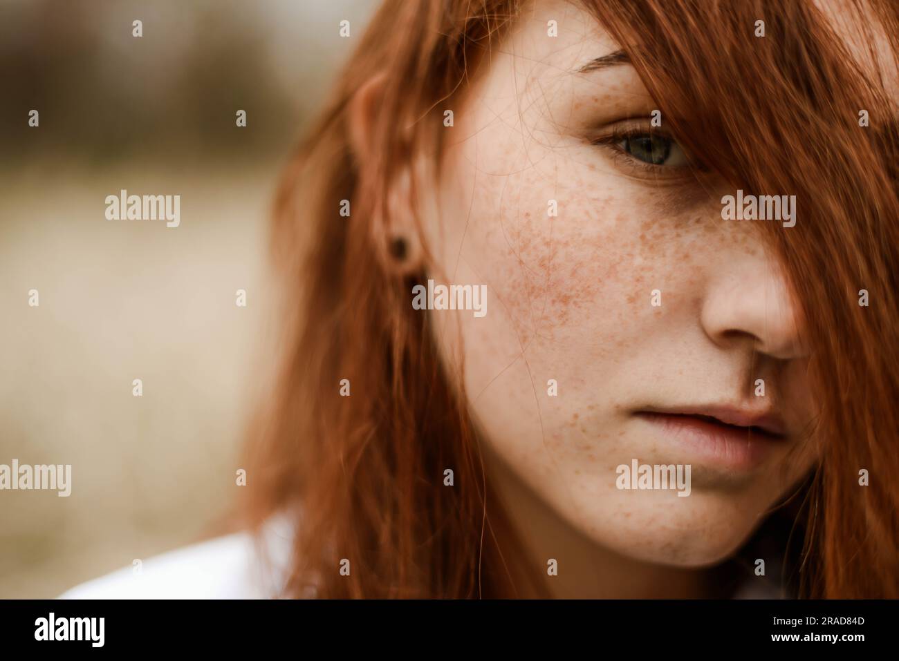 Close-up portrait of teenage girl with red head Banque D'Images