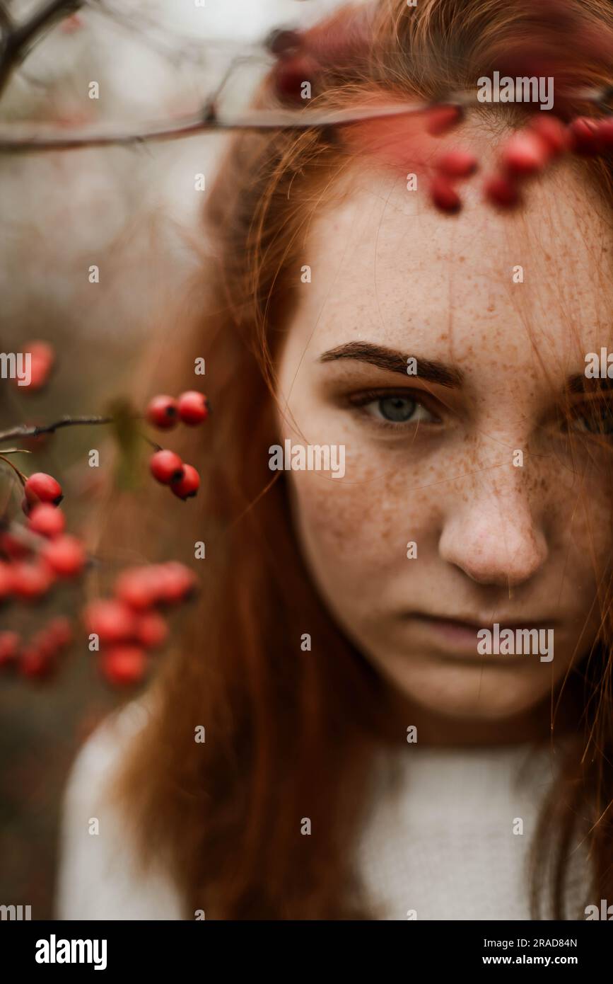 Close-up portrait of teenage girl with red head Banque D'Images