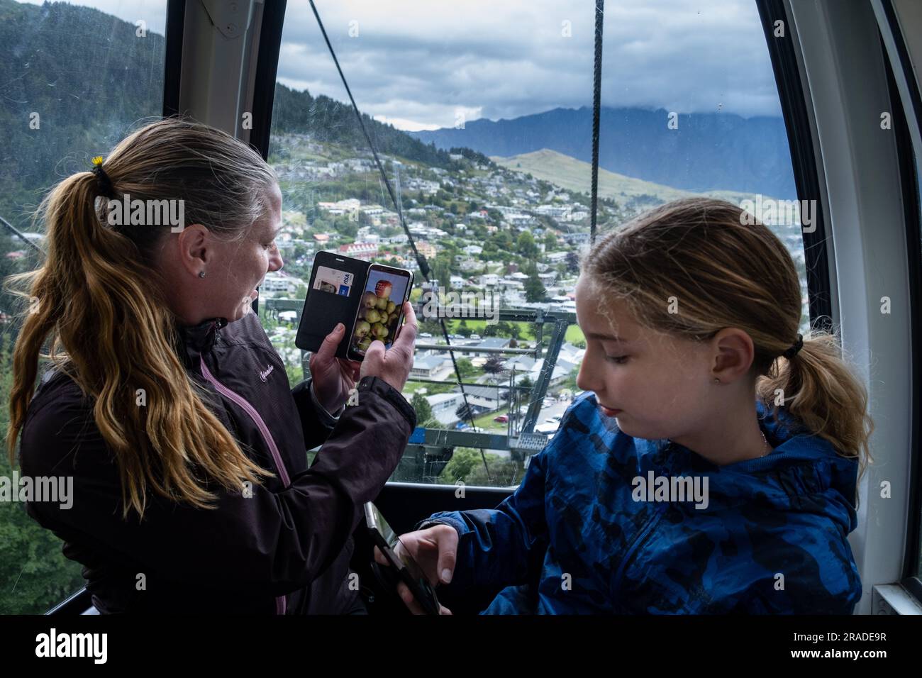Une mère et sa fille prennent des photos dans le téléphérique jusqu'à Skyline Resort sur Bob's Peak à Queenstown, en Nouvelle-Zélande. Photo : Rob Watkins Banque D'Images