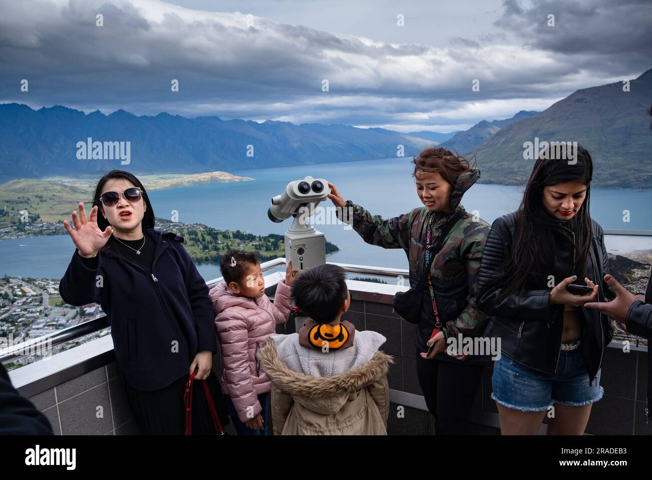 Les touristes asiatiques prennent des photos de téléphone portable au Skyline Resort sur Bob's Peak au-dessus de Queenstown et du lac Wakatipu en Nouvelle-Zélande. Photo : Rob Watkins Banque D'Images