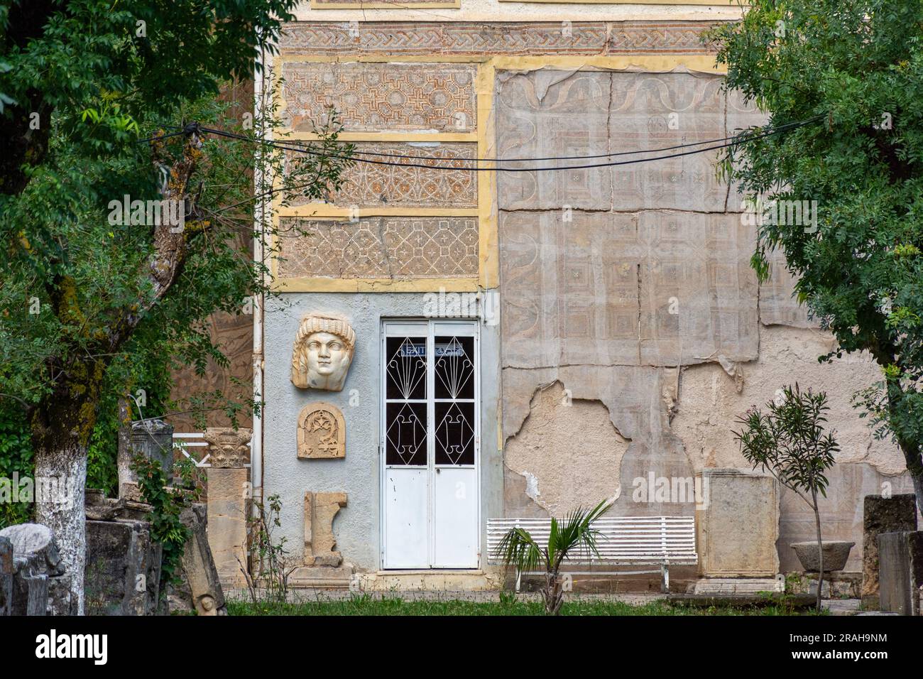 Vue d'une statue antique à tête géante d'un empereur romain sur le mur du musée Cuicul. Banque D'Images