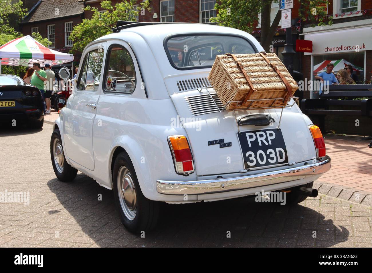Fiat 500 restaurée de 1966, dormant au soleil, avec panier pique-nique en osier monté sur le capot moteur lors d'un événement de voiture italienne, mai 2023. Banque D'Images