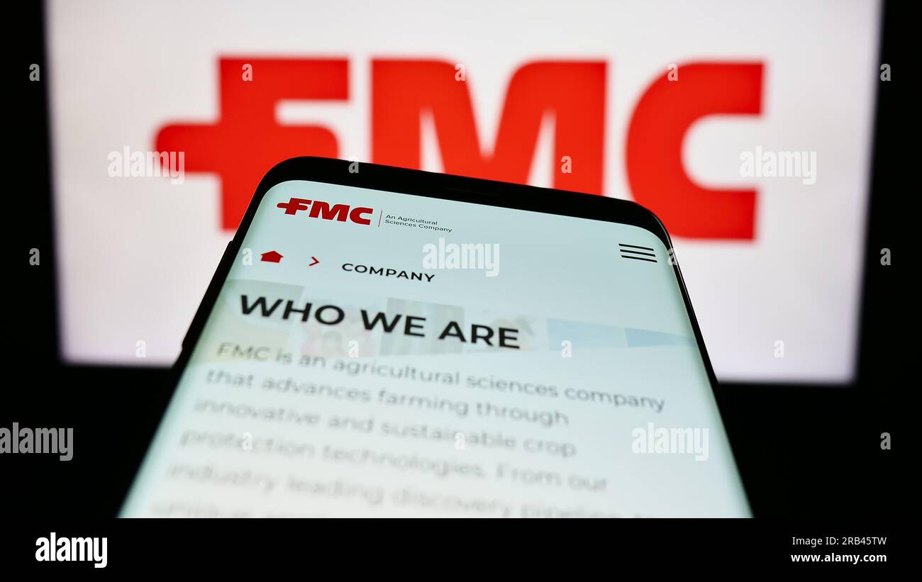 Smartphone avec la page Web de la société chimique américaine FMC Corporation sur l'écran devant le logo de l'entreprise. Effectuez le focus sur le coin supérieur gauche de l'écran du téléphone. Banque D'Images