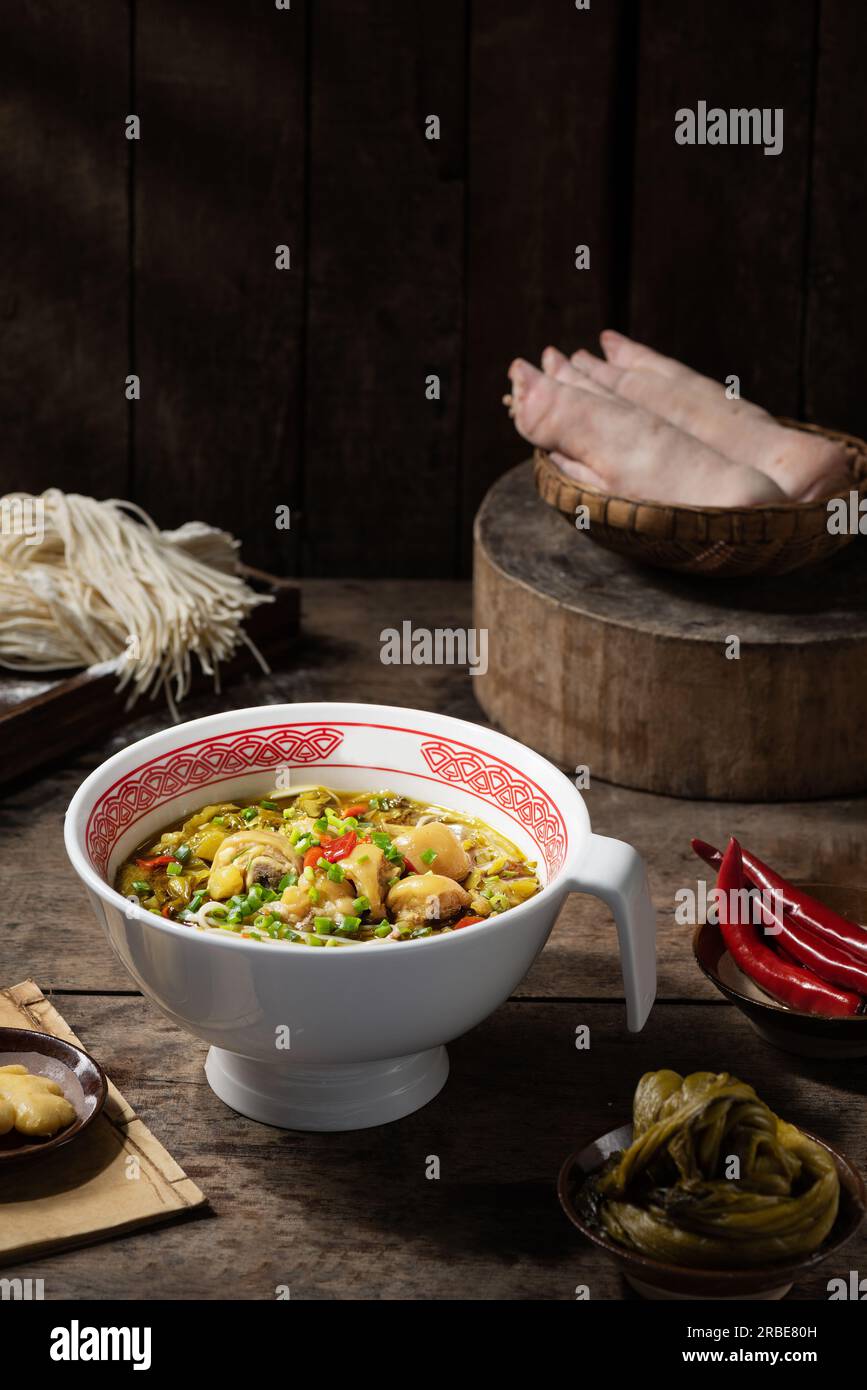 Trotteurs de porc braisés （porc Hock，pieds de porc）nouilles au chou acide Banque D'Images
