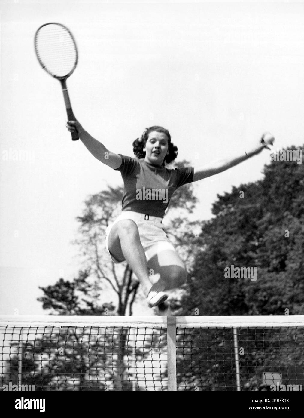 Westport, Connecticut : 23 mai 1936 la femme de 18 ans sautant sur le filet de tennis a été nommée «athlète américaine typique» par le comité athlétique du Longshore Club à Westport. Banque D'Images
