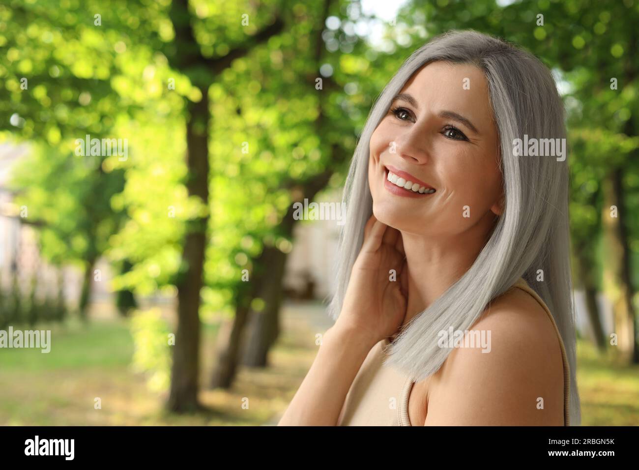 Portrait de femme souriante avec la couleur des cheveux de cendre à l'extérieur. Espace pour le texte Banque D'Images