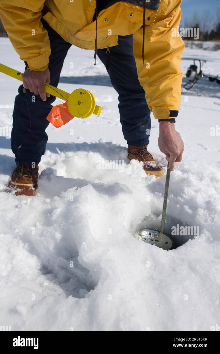 Homme nettoyant un trou de pêche, Parc des îles Boucherville, Québec, Fishing Hole, Canada Banque D'Images
