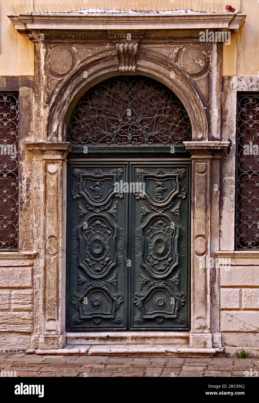 Une ancienne porte décorée en bois vert dans l'ancien ghetto de Venise Banque D'Images
