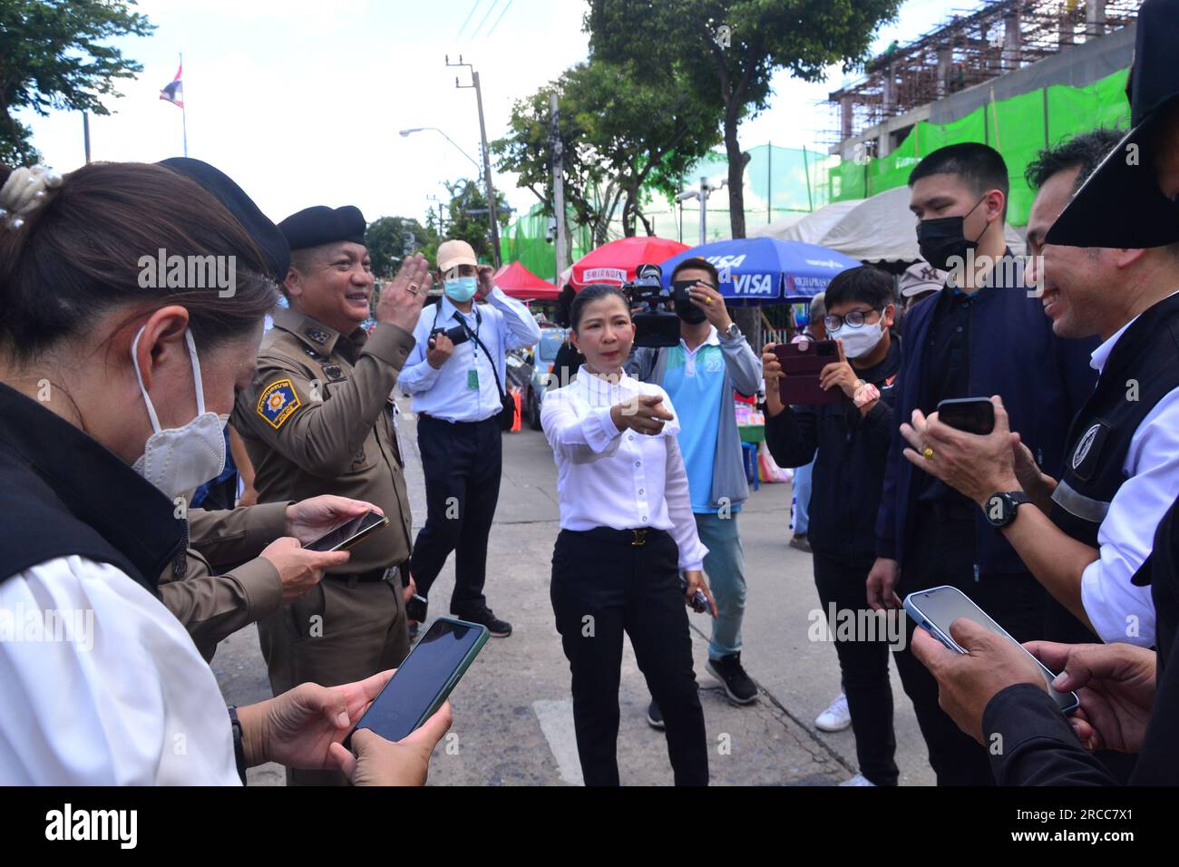 Le directeur de l'administration Dusit, le gouvernement local dans ce domaine, discute avec les policiers de Bangkok des arrangements. Manifestation des partisans du parti Move Foward près du Parlement, Bangkok, Thaïlande. Le Parlement thaïlandais a voté le 13 juillet pour décider si le leader du parti Move Forward, Pita Limjaroenrat, qui a remporté le plus grand nombre de sièges aux élections de mai, peut devenir le nouveau Premier ministre, mettant fin à 9 ans de règne de l'ancien chef de l'armée Prayuth Chan-ocha. L'administration locale a mis à disposition une zone voisine avec une bonne vue du Parlement. Pita Limjaroenrat a perdu le vote. Banque D'Images