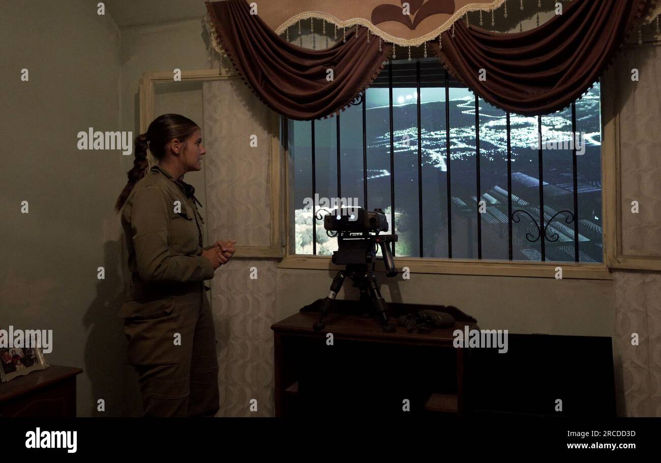 Une soldat israélienne regarde une vue virtuelle à l'intérieur d'une pièce qui simule une résidence arabe au Centre d'entraînement à la guerre urbaine de Tze'elim de l'armée israélienne le 12 juillet 2023 dans le désert du Néguev, en Israël. Le Tse'elim Urban Warfare Training Center surnommé 'Baladia' (arabe pour 'district') est une maquette d'un village générique du moyen-Orient construit et financé en grande partie par l'aide militaire américaine, pour la formation des unités de combat, et se compose d'une imitation de la ville de style arabe. Banque D'Images