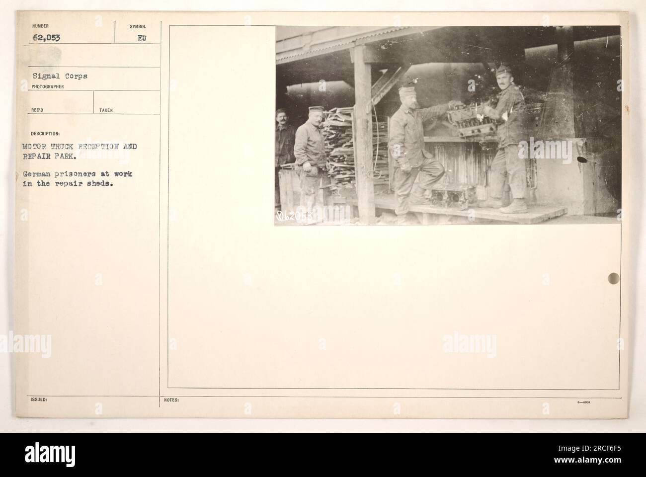 On montre des prisonniers allemands travaillant au Motor Truck Reception and Repair Park pendant la première Guerre mondiale. Cette photographie, prise par Wonder 62 053 du signal corps, capture les prisonniers effectuant des réparations dans les hangars de réparation. Il donne un aperçu des activités des prisonniers allemands qui ont été impliqués dans le soutien des efforts militaires américains pendant la guerre. Banque D'Images