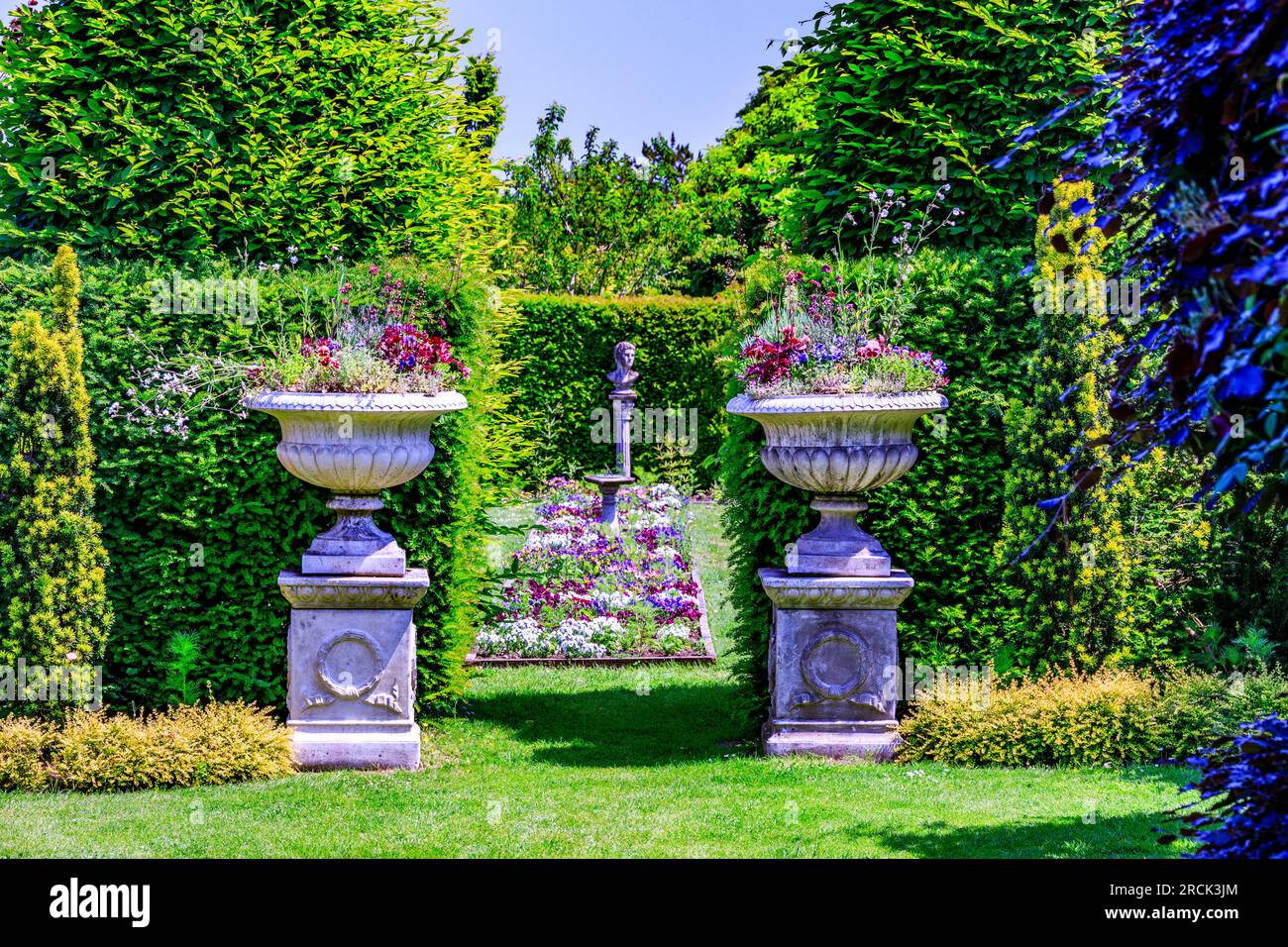 Les hautes haies distinctives et la bordure centrale colorée du Canal Garden à Holme Gardens jardins paysagers près de Wareham, Dorset, Angleterre, Royaume-Uni Banque D'Images