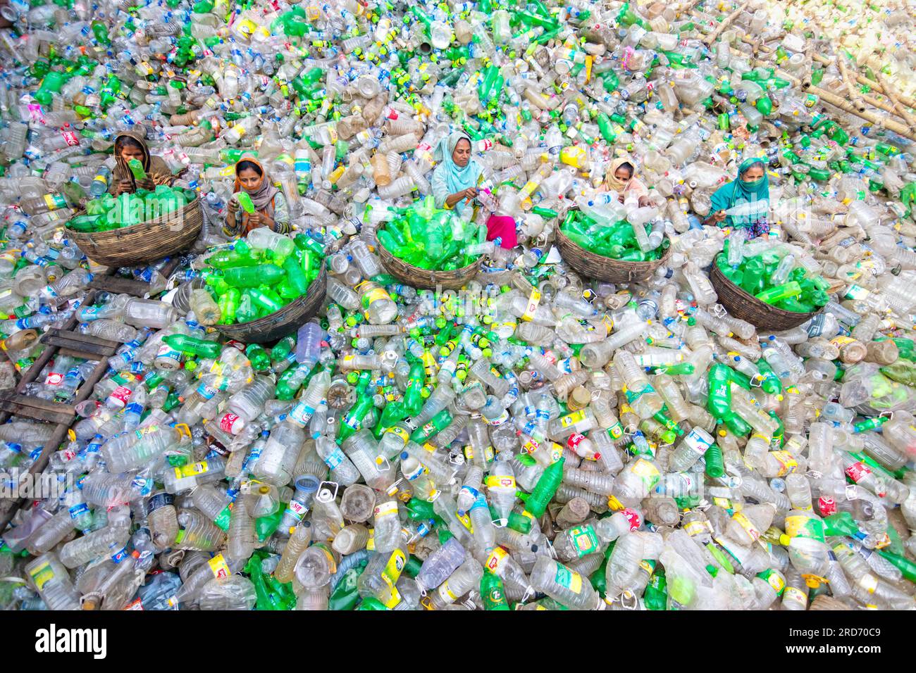 Dhaka, Bangladesh. 19 juillet 2023, Dhaka, Dhaka, Bangladesh : des ouvriers trient des bouteilles en plastique usagées dans une usine de recyclage à Dhaka, Bangladesh. Les employés aident à éviter que les bouteilles ne soient jetées, envoyées à la décharge, où elles peuvent prendre 1 000 ans à se biodégrader, ou incinérées, ce qui produit des fumées toxiques. La capitale bangladaise, Dhaka, étant l'une des plus densément peuplées au monde et abritant près de 19 millions d'habitants, la consommation annuelle de plastique par habitant de Dhaka est plus de trois fois supérieure à la moyenne nationale des zones urbaines et s'élève à 22,25 kg. Crédit : ZUMA Press, Inc./Alamy Live News Banque D'Images