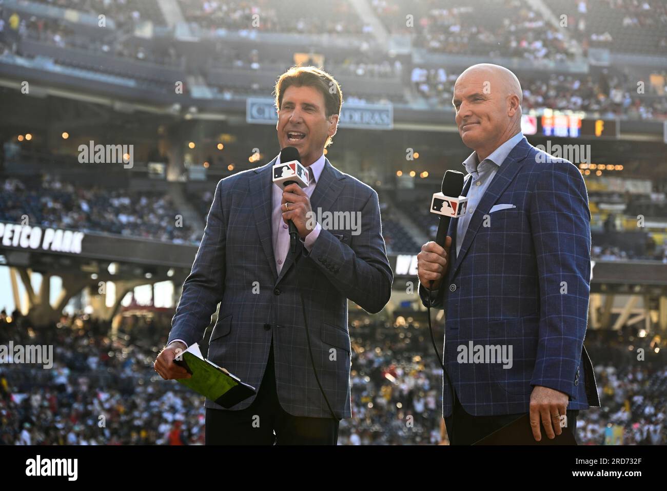 MLB broadcasters Mike Pomeranz, left, and Mark Sweeney speak before a baseball game between the Los Angeles Angels and the San Diego Padres on Monday, July 3, 2023, in San Diego. MLB's takeover of San Diego Padres' broadcasts involved months of planning, a playbook MLB is following this week with Arizona Diamondbacks' telecasts. (AP Photo/Denis Poroy) Banque D'Images