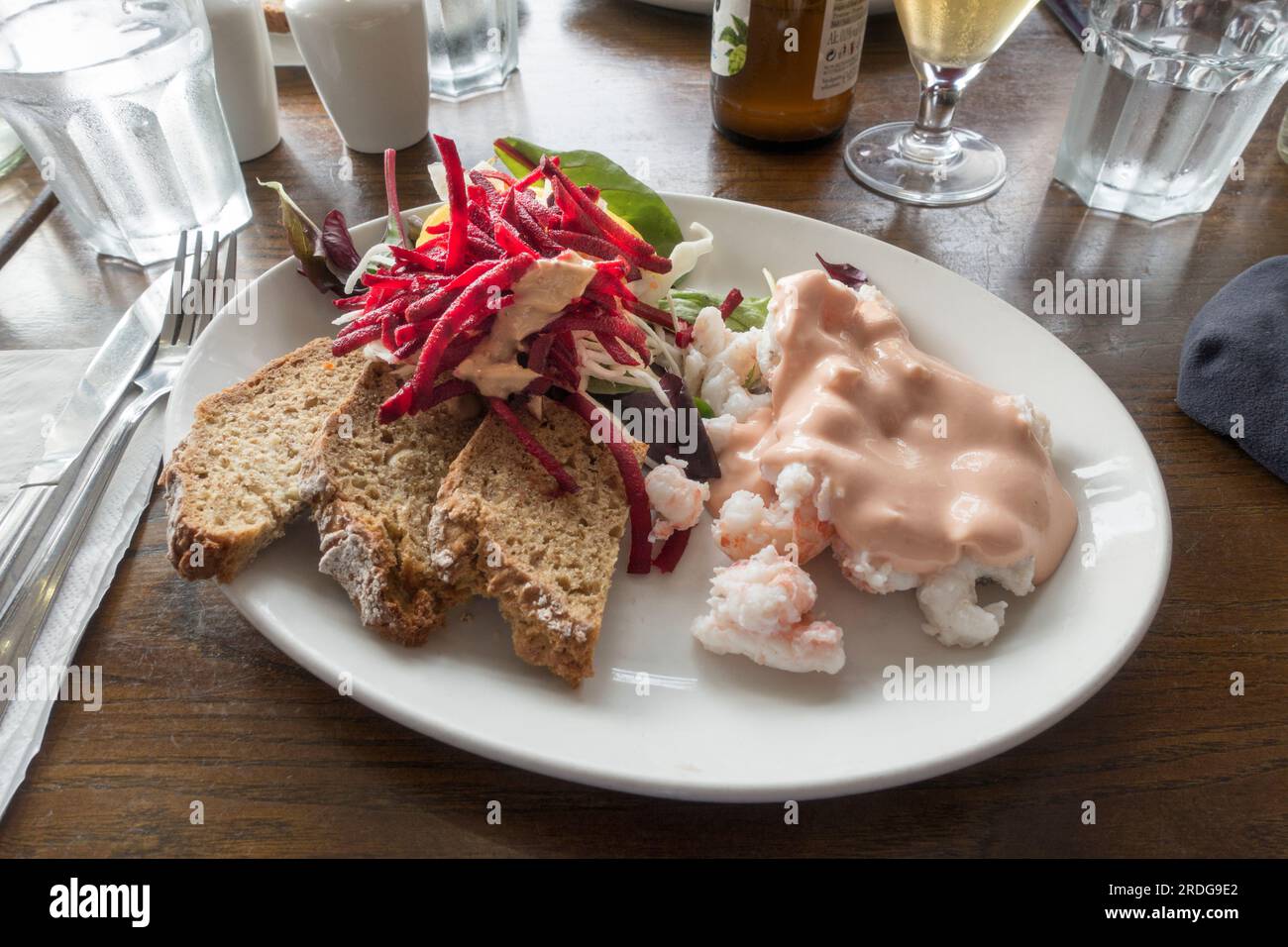 Assiette ouverte de crevettes, pain brun, sauce marie rose et salade dans un pub gastronomique irlandais en bord de mer Banque D'Images