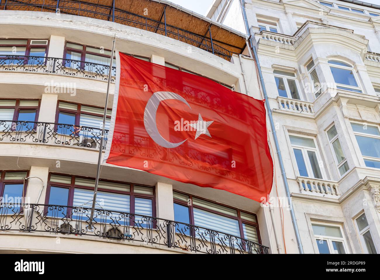 Une photo d'un grand drapeau turc agitant devant un immeuble d'appartements. Banque D'Images