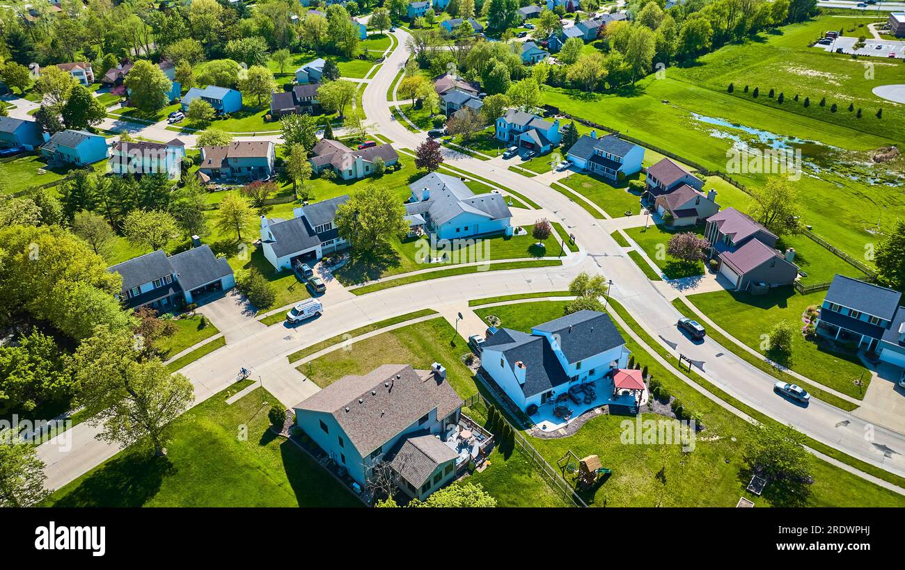 Faire des routes serrées à travers un petit quartier avec un ruissellement d'eau à proximité en avion Banque D'Images