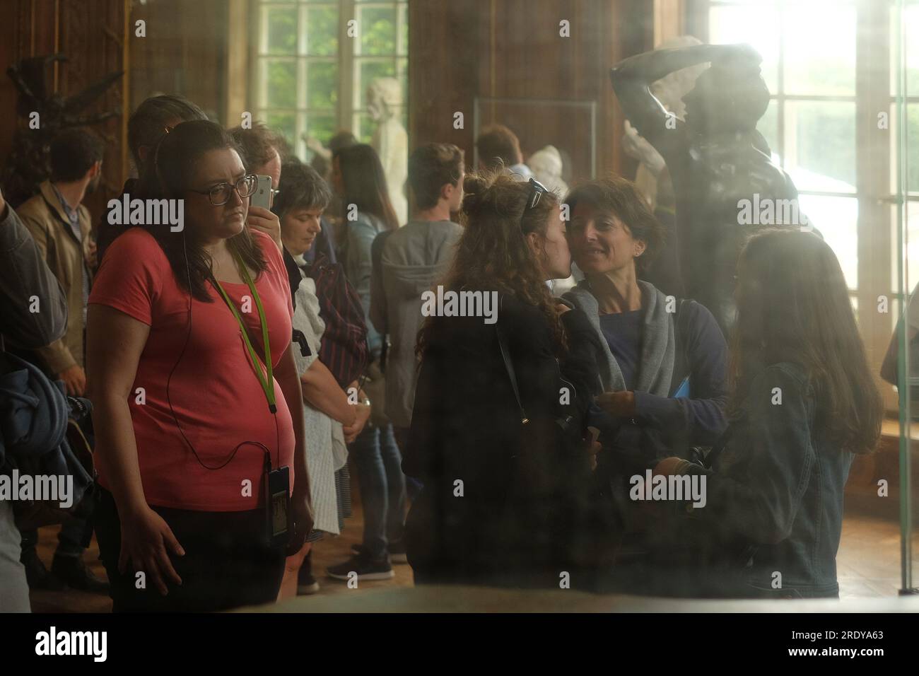 Une scène atténuée par son reflet dans un miroir antique tacheté, les gens regardant la sculpture en bronze l'âge du bronze à l'intérieur du Musée Rodin, Paris, France. Banque D'Images