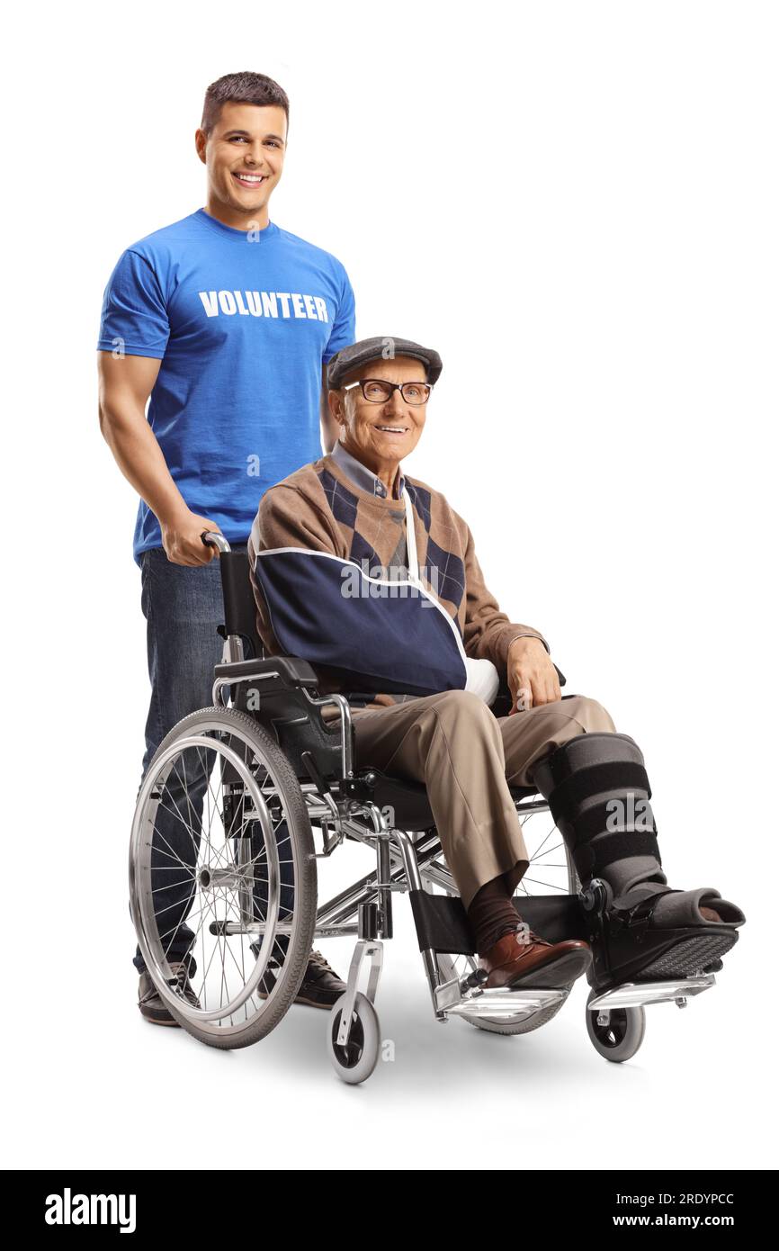 Bénévole aidant un homme âgé blessé avec une attelle de jambe dans un fauteuil roulant isolé sur fond blanc Banque D'Images