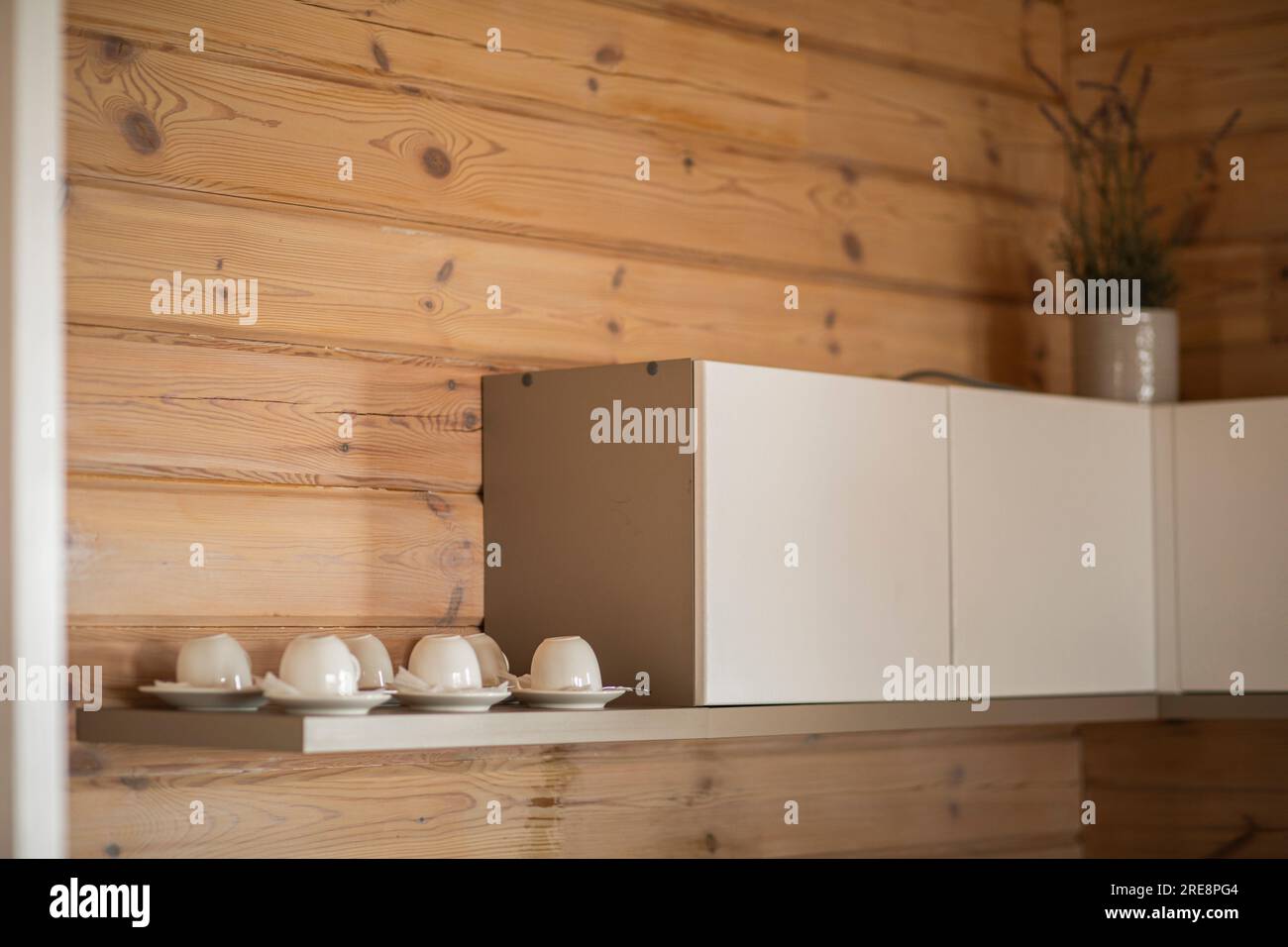 cuisine de ferme confortable avec armoires en bois rustique et vaisselle sur le mur Banque D'Images