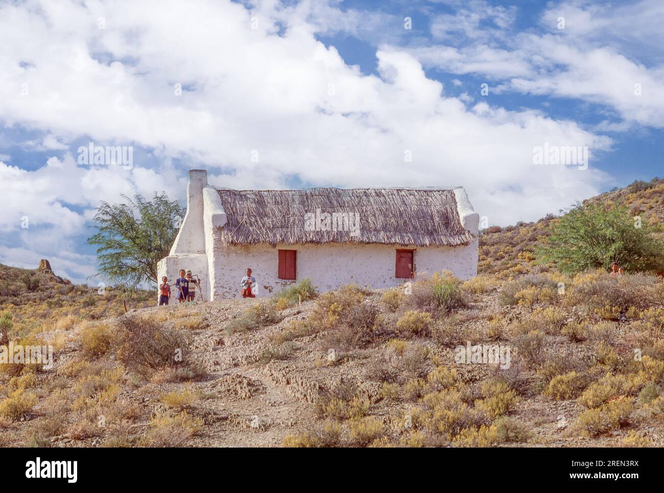 Enfants devant un chalet de chaume près du pied du col Robinson dans les montagnes Outeniqua de la province du Cap occidental en Afrique du Sud. Banque D'Images