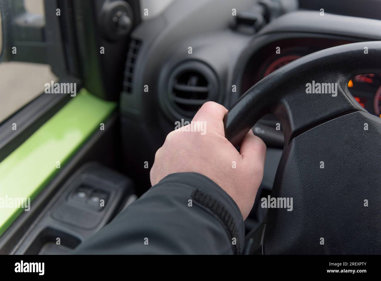 Une main d'homme sur le volant d'une voiture. Gros plan. Direction. foyer sélectionné. Banque D'Images