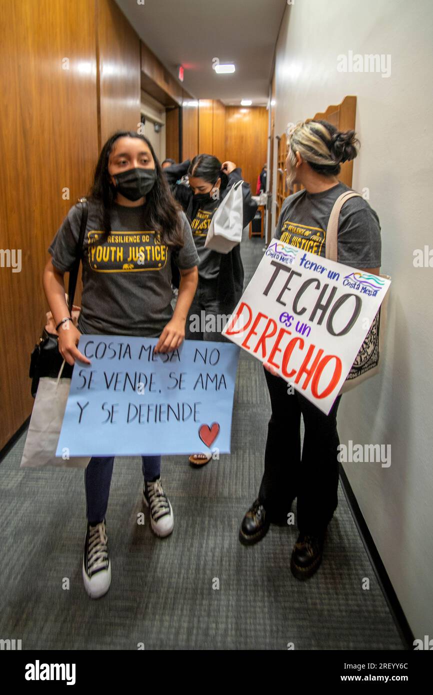 Des manifestants hispaniques se rassemblent à l'hôtel de ville de Costa Mesa, en Californie, portant des panneaux bilingues exigeant le contrôle des loyers pour les locataires à faible revenu de la ville. Banque D'Images