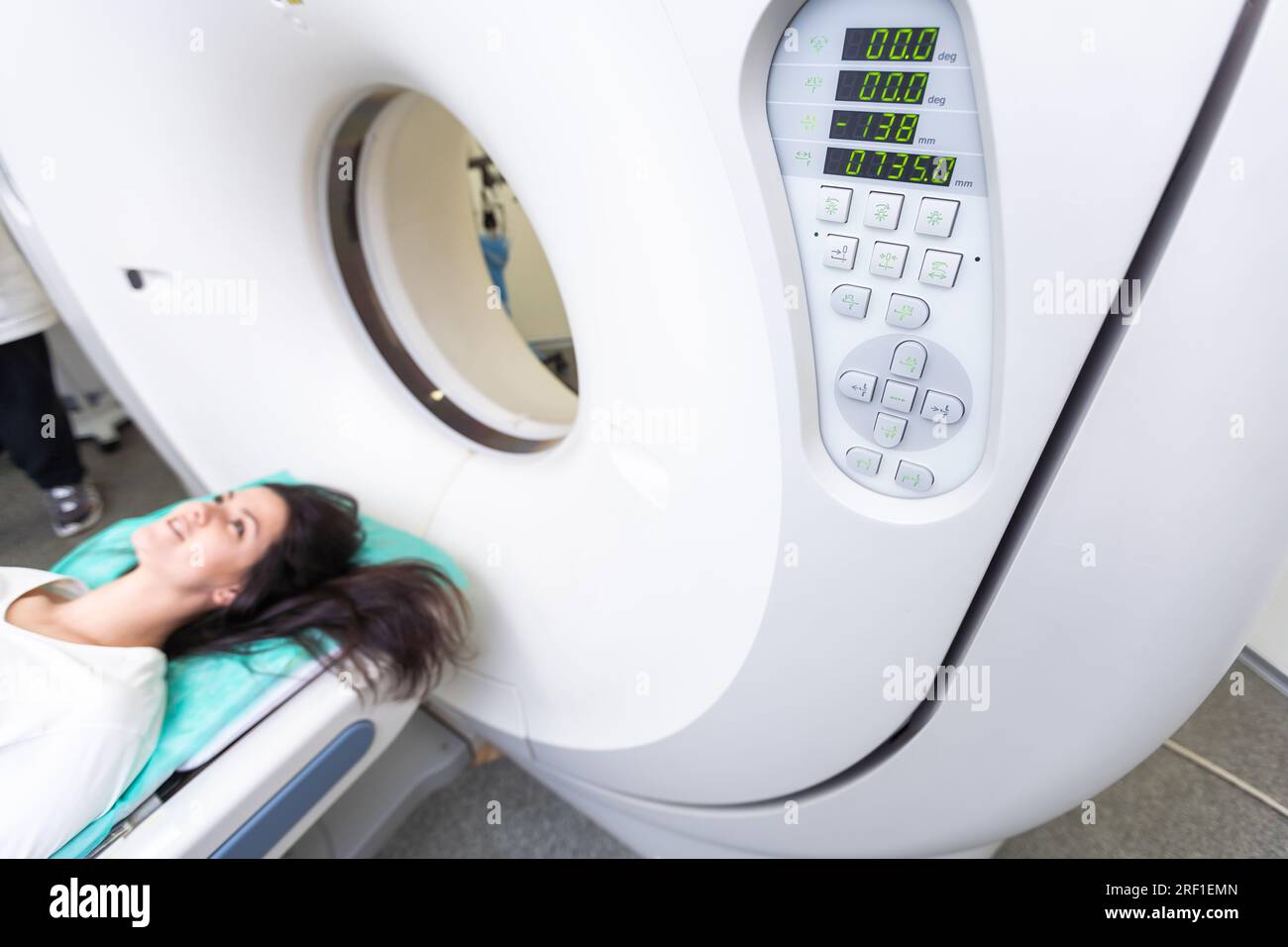 Un technologue en acquisition CT qui regarde le patient dans le scanner de tomodensitométrie pendant la préparation de la procédure. Femme entrant dans le scanner CT. Banque D'Images