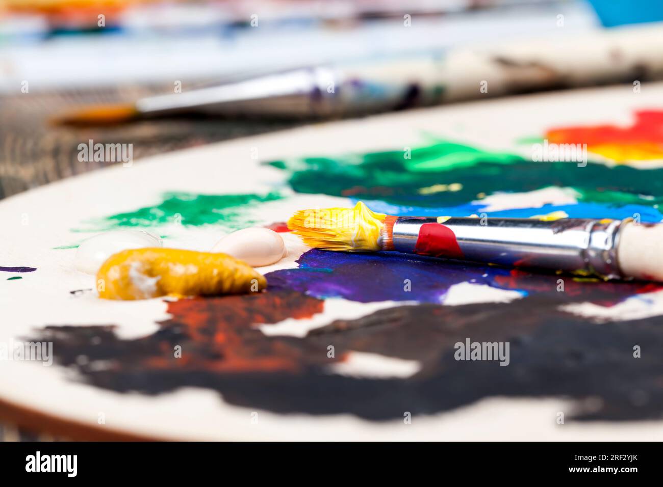 le processus créatif de dessin en mélangeant différentes couleurs de peintures avec des pinceaux d'art, des pinceaux d'art et des peintures pour peindre des images, de l'huile et d'autres pai Banque D'Images