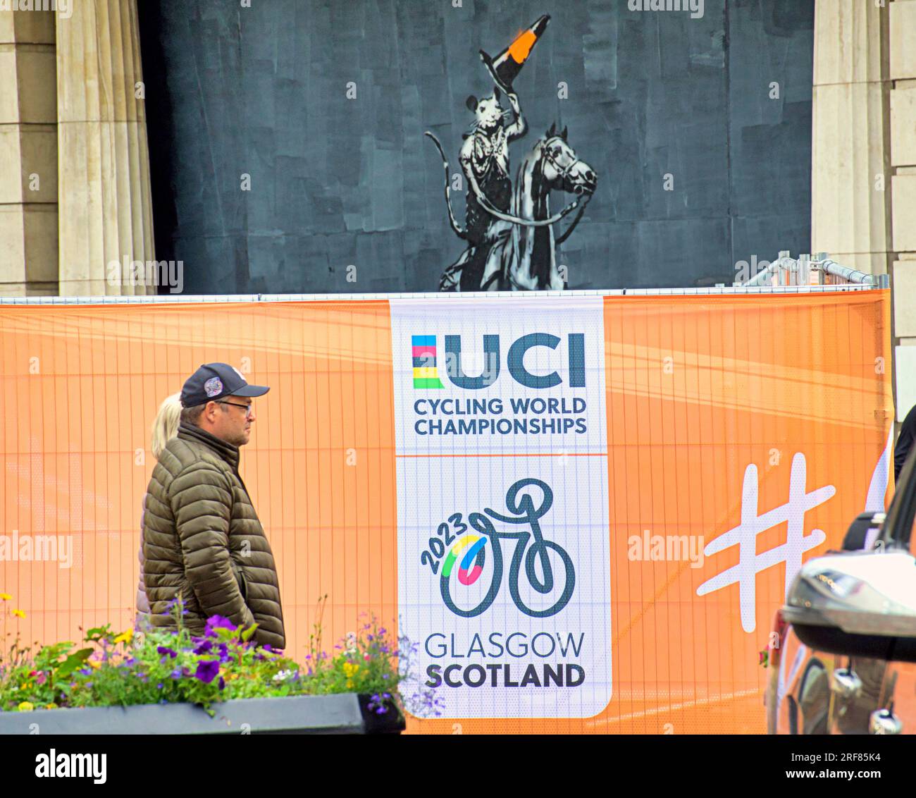 Glasgow, Écosse, Royaume-Uni 31 juillet 2023. Des barrières anti-terroristes UCI sont installées pour les championnats du monde dans les rues de la ville et canalisent les foules pour la vérification des bagages avec la circulation et les barrières. Banksie cône tête Duke Tribute sur Argyle Street lève son chapeau à la foule de l'uci. Crédit Gerard Ferry/Alamy Live News Banque D'Images