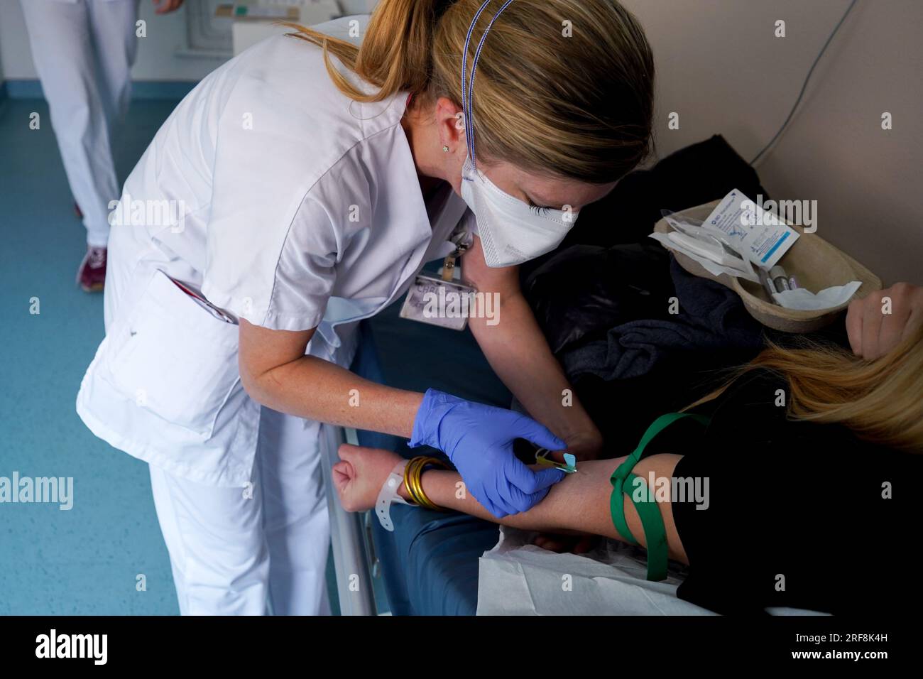 Une infirmière effectue un test sanguin dans la salle d'urgence d'un hôpital universitaire. Banque D'Images