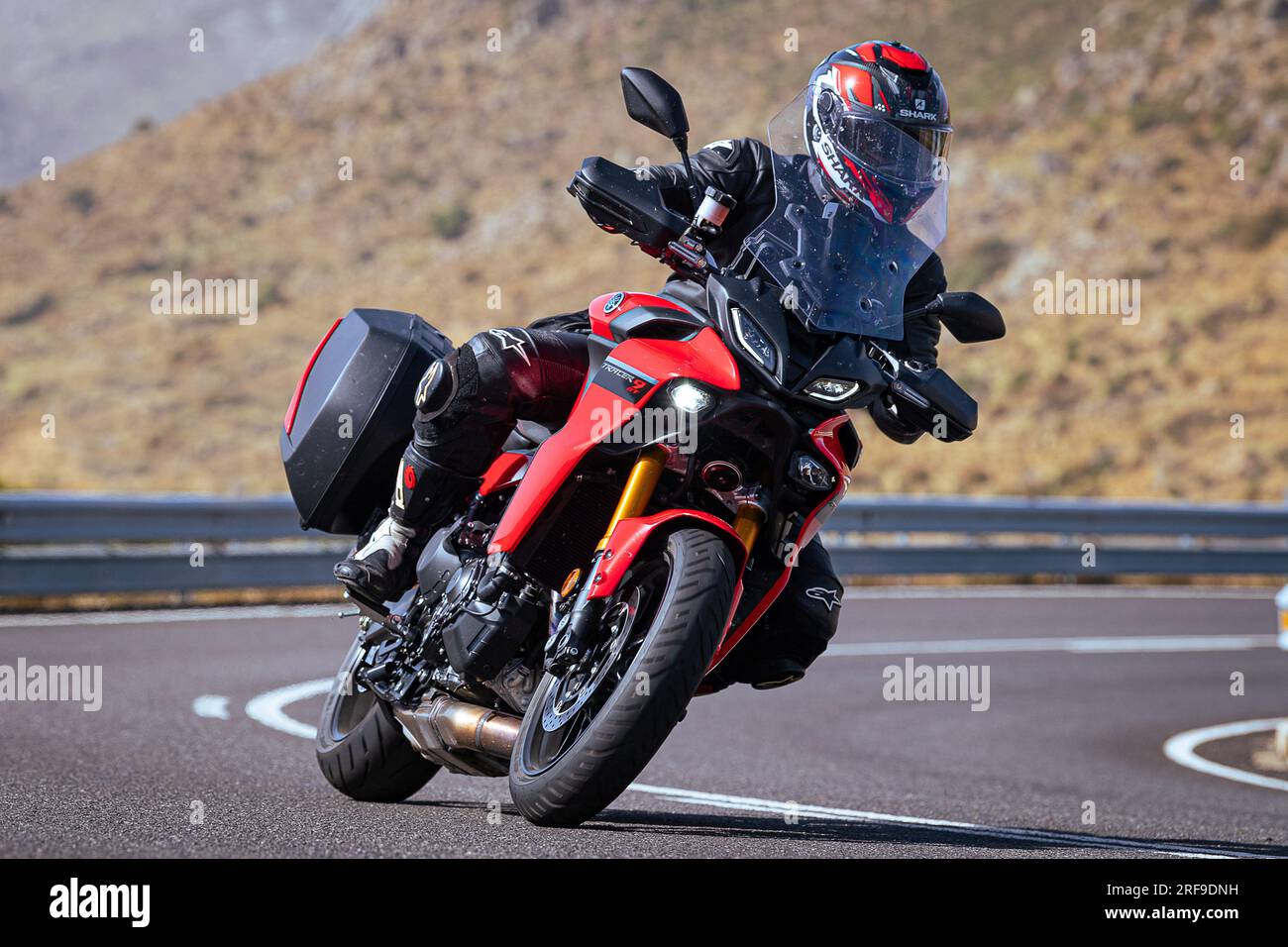 le motocycliste prend une courbe nette sur sa moto. Photographie prise dans le port de Navalmoral, province de la ville d'Avila, Espagne, pendant la journée Septem Banque D'Images