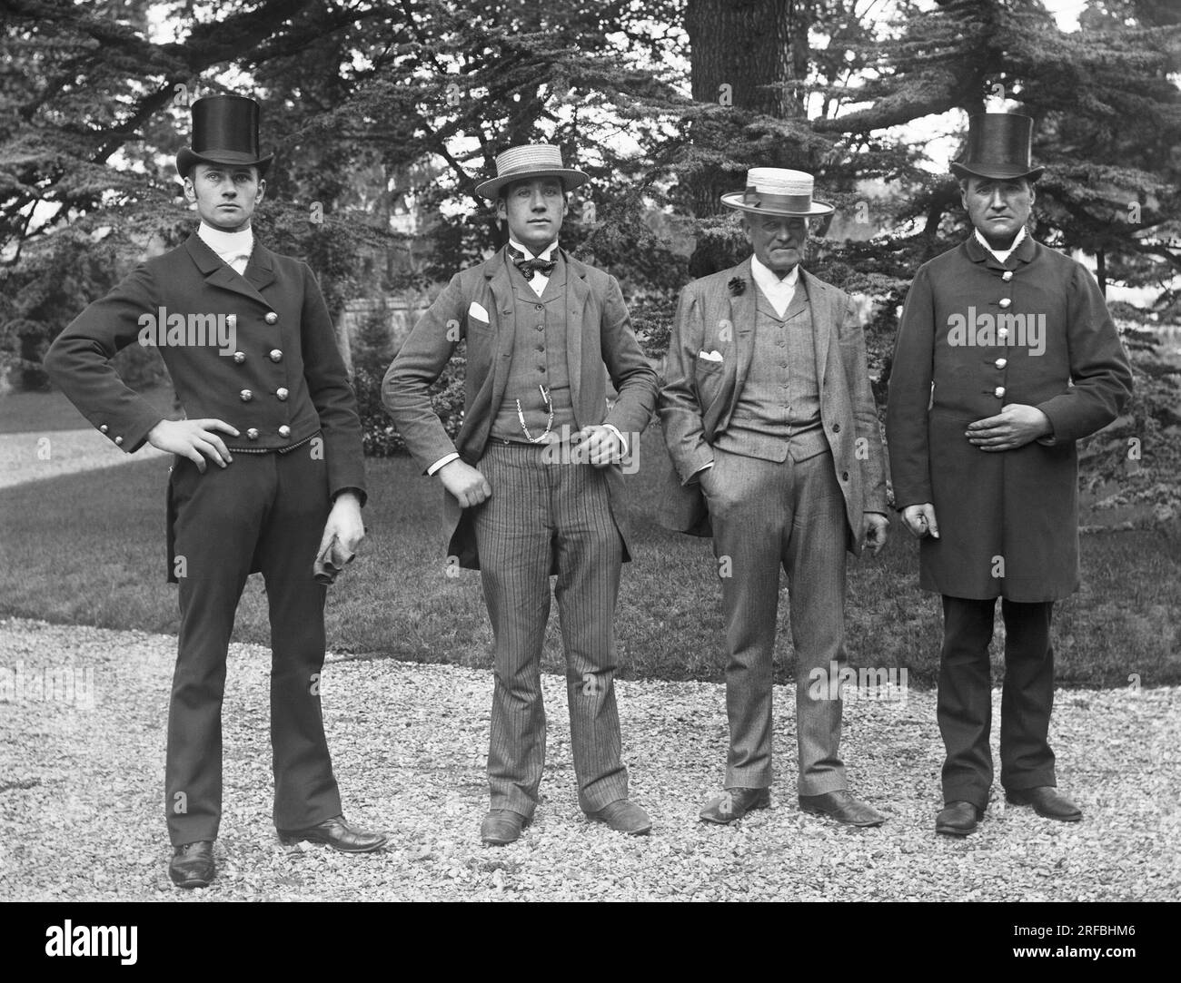 Portraits d'hommes, deux d'entre eux en costumes et canotiers, encadres des deux autres en habit et chapeaux haut-de-forme, posant dans le jardin de l'abbaye de Septfontaine, a Andelot Blancheville, pres de Chaumont en haute Marne. Photographie vers 1886 de Paul Emile Theodore Ducos (1849-1913). Banque D'Images