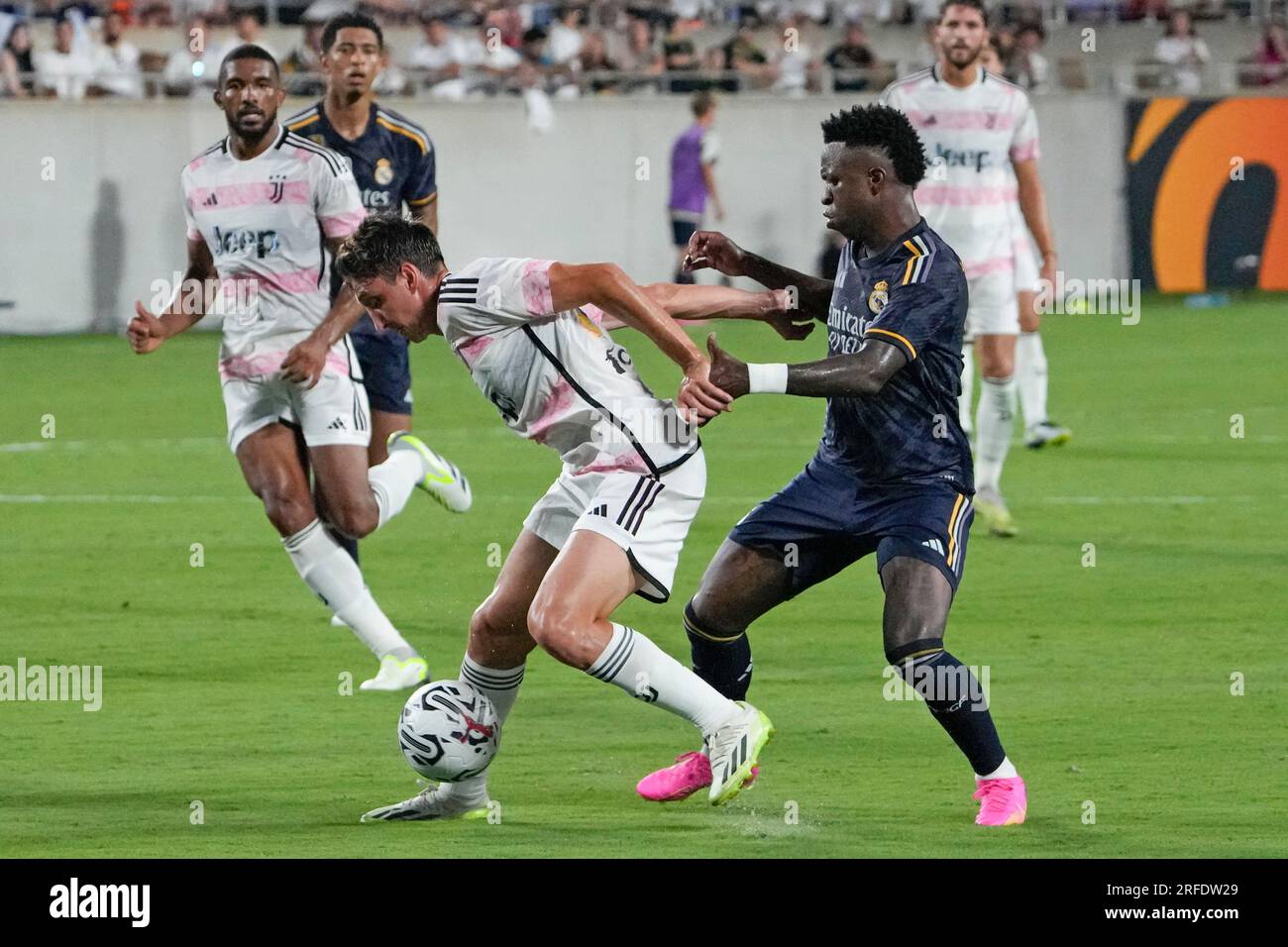 Real Madrid forward Vinicius Jose Paixao, right, tries to stop Juventus midfielder Andrea Cambiaso, front left, from advancing the ball during the second half of a Champions Cup soccer match Wednesday, Aug. 2, 2023, in Orlando, Fla. (AP Photo/John Raoux) Banque D'Images