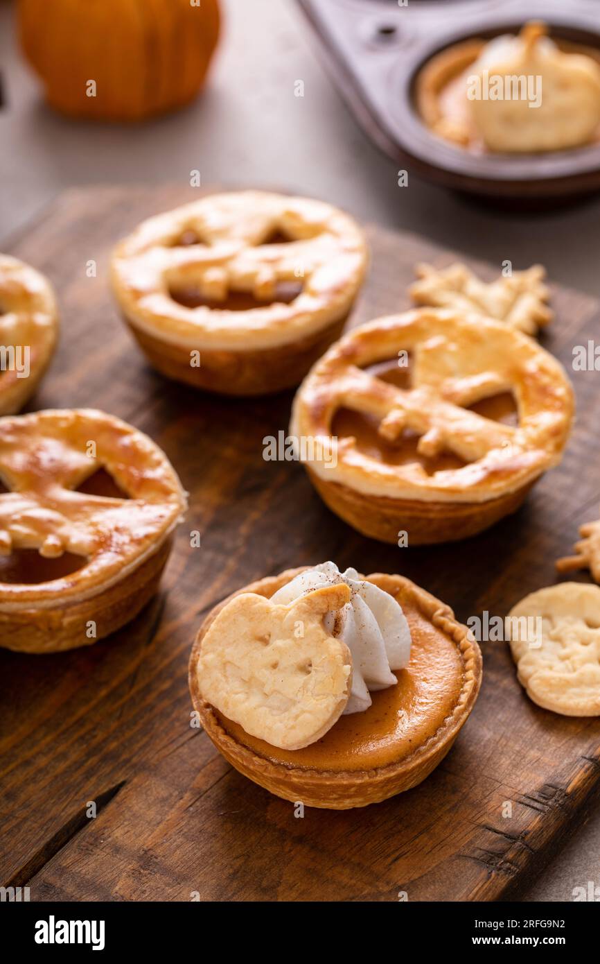 Mini tartes à la citrouille pour Halloween surmontées de lanternes Jack o et de crème fouettée Banque D'Images