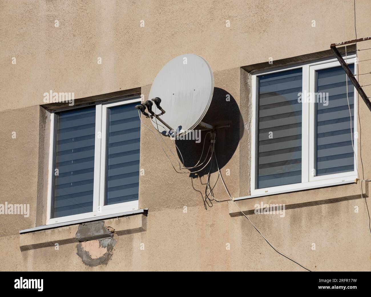 TV satellite parabolique antenne attachée au mur de la maison. Banque D'Images