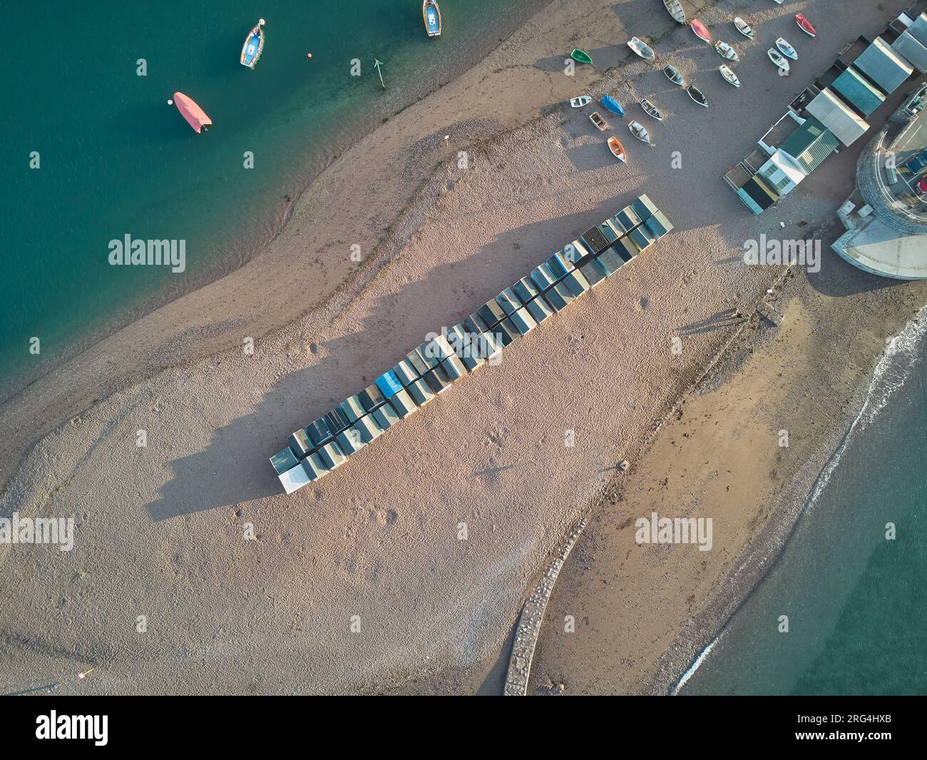 Un banc de sable à l'embouchure de la rivière, avec des cabanes de plage sur le sable, des bateaux amarrés dans l'eau ; dans l'embouchure de la rivière Teign, Teignmouth, Devon, Grande-Bretagne. Banque D'Images