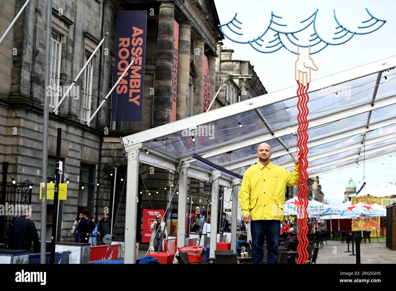 Édimbourg, Écosse, Royaume-Uni. 7 août 2023. Edinburgh Fringe:Kostya Benkovich présentant la sculpture de la main droite de Dieu dans George Street Gardens, la main droite de Dieu confond l'iconographie médiévale traditionnelle relative à ce geste comme symbole de miséricorde, d'omnipotence et de refuge. Kostya Benkovich pose à côté de la sculpture. Craig Brown/Alamy Live News Banque D'Images