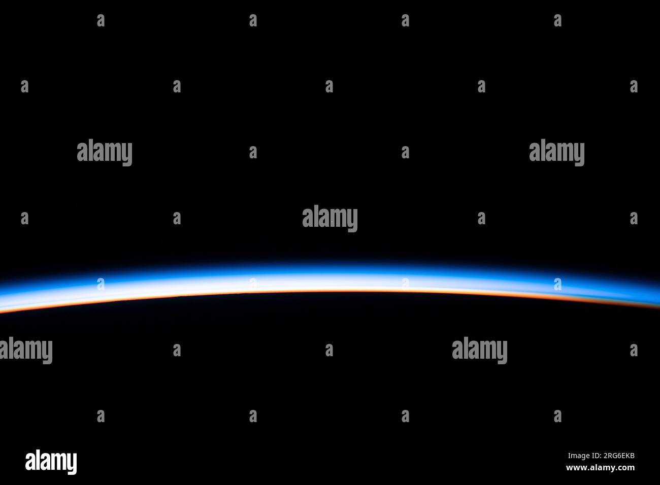 Les premiers rayons d'un lever de soleil orbital éclairent le membre de la Terre et mettent en évidence l'atmosphère. Banque D'Images