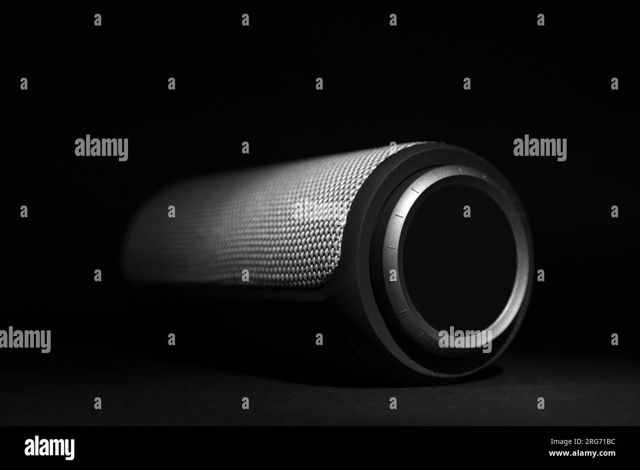Un haut-parleur bluetooth portable sur fond noir, gros plan. Équipement audio Banque D'Images