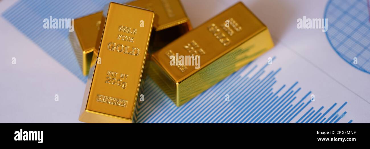 Les barres d'or sur les rapports financiers et les graphiques se rapprochent. Banque D'Images