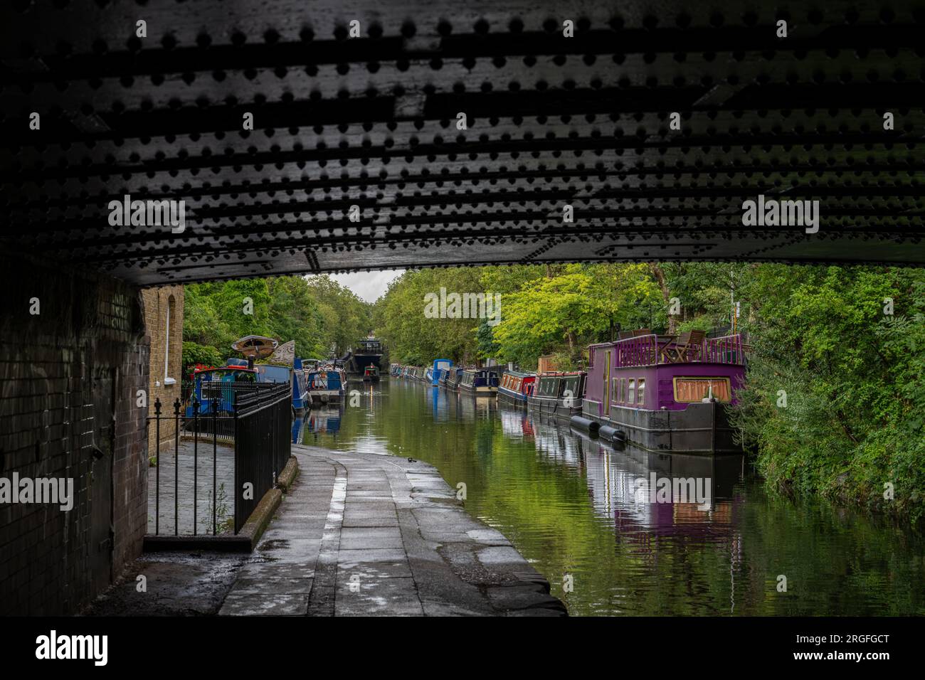 Londres, Royaume-Uni : Péniches à Blomberg Road Moorings sur Regent's Canal à Londres, une partie de la région connue sous le nom de Little Venice. Vu de sous un pont. Banque D'Images