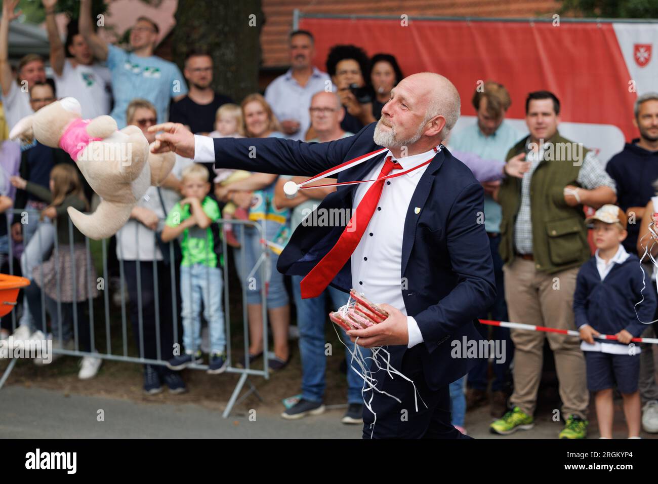 Vechta, Allemagne. 10 août 2023. Un peluche est jeté dans la foule pendant le défilé au Stoppelmarkt. La fête traditionnelle a lieu depuis 725 ans. L'invité d'honneur à l'ouverture est LILO Wanders. Crédit : Friso Gentsch/dpa/Alamy Live News Banque D'Images