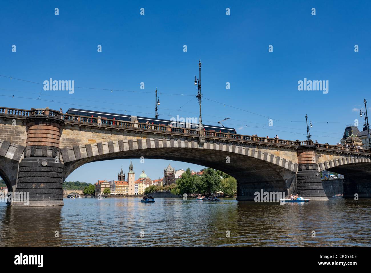 'Most Legií' (Pont des légions) sur la rivière Vltava à Prague. Tramp passe au-dessus du pont, complexe de construction 'Karlovy Lázně' en arrière-plan. Banque D'Images